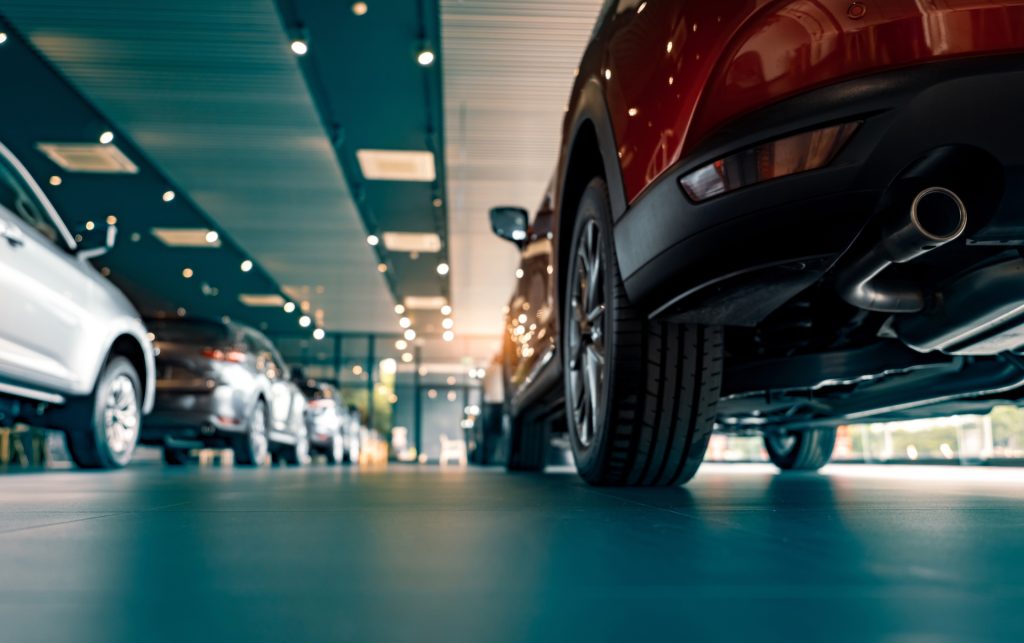 Row of new vehicles on display in the Massy Motors showroom